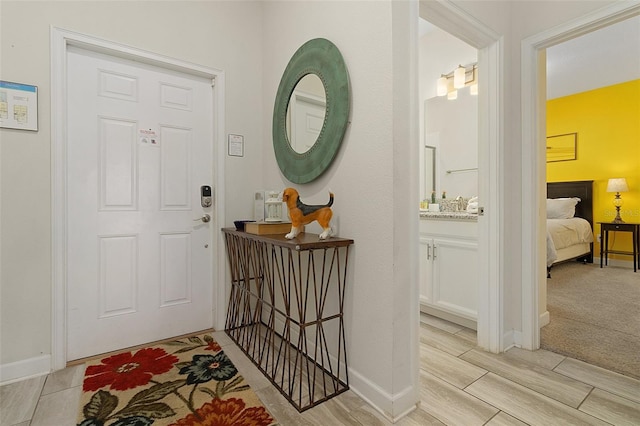 foyer entrance featuring light carpet