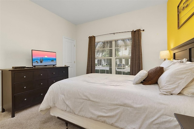 bedroom featuring light colored carpet