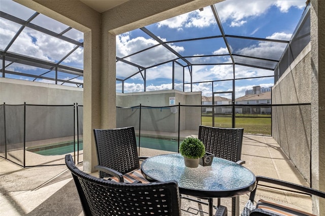 view of patio featuring glass enclosure