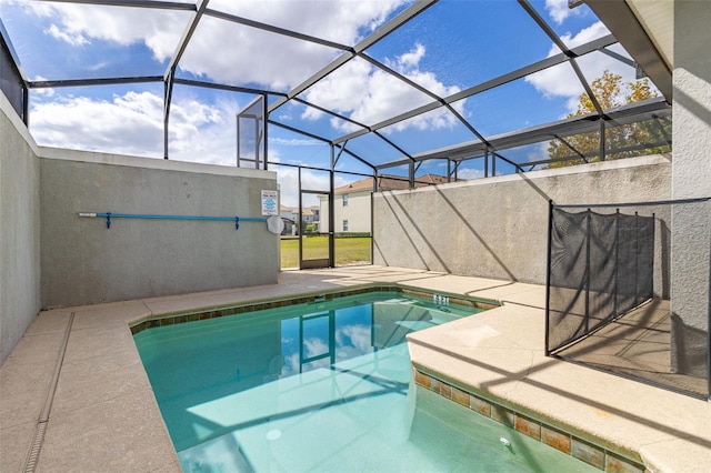 view of pool featuring glass enclosure and a patio