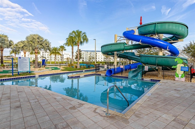 view of pool featuring a patio area and a water slide