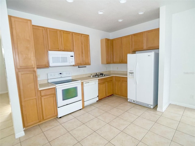 kitchen with white appliances, sink, and light tile flooring