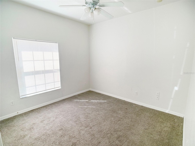 carpeted spare room with ceiling fan