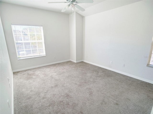 spare room featuring light carpet and ceiling fan