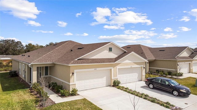 view of front of home featuring a garage and a front lawn