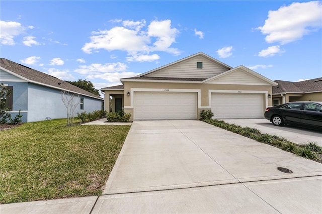 view of front of property featuring a front lawn and a garage