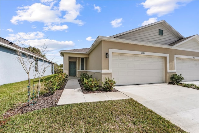 view of front of home featuring a front lawn and a garage