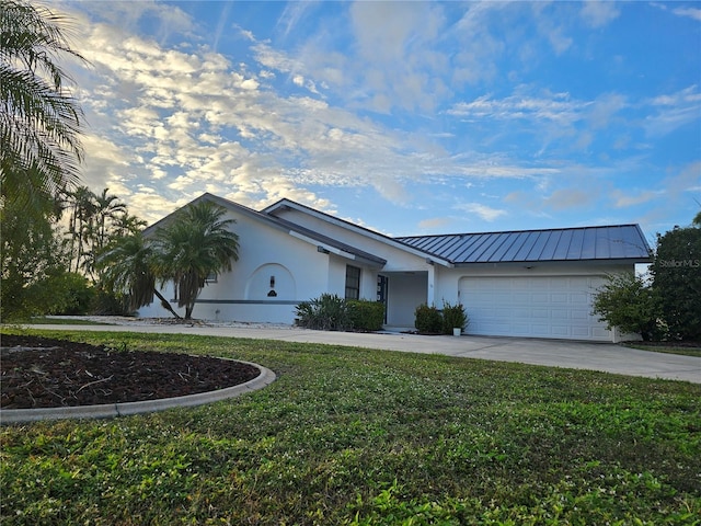 view of front of home with a front yard and a garage