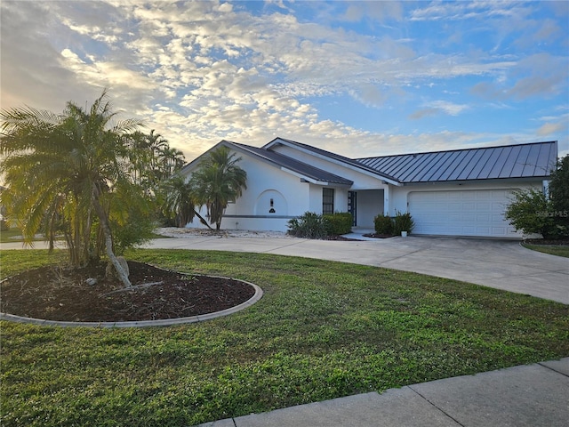 single story home featuring a front yard and a garage