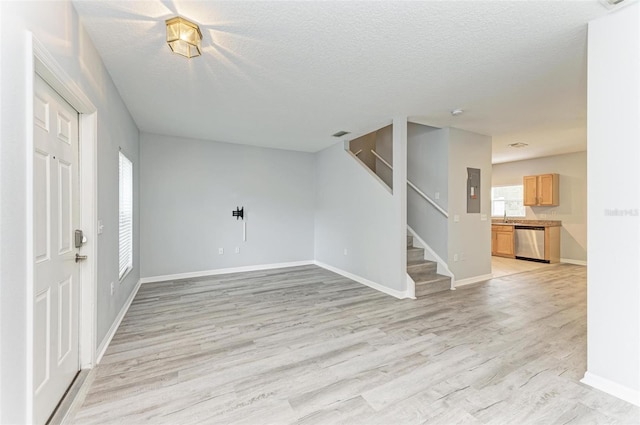 entrance foyer featuring light hardwood / wood-style floors and a textured ceiling