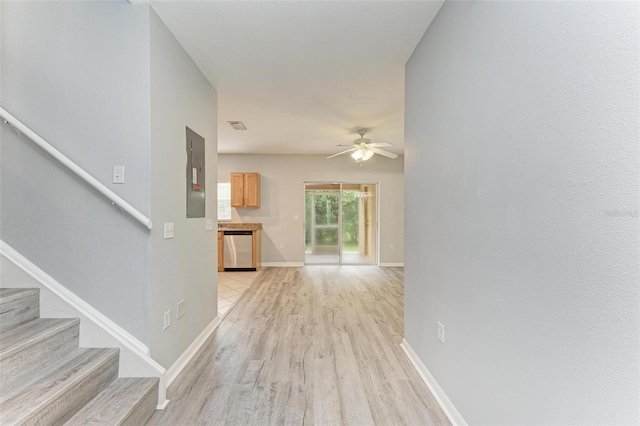 hall featuring electric panel and light hardwood / wood-style flooring