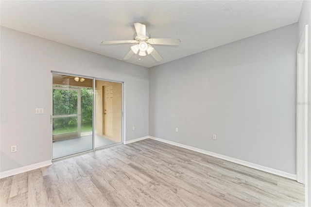 empty room with ceiling fan and light hardwood / wood-style floors