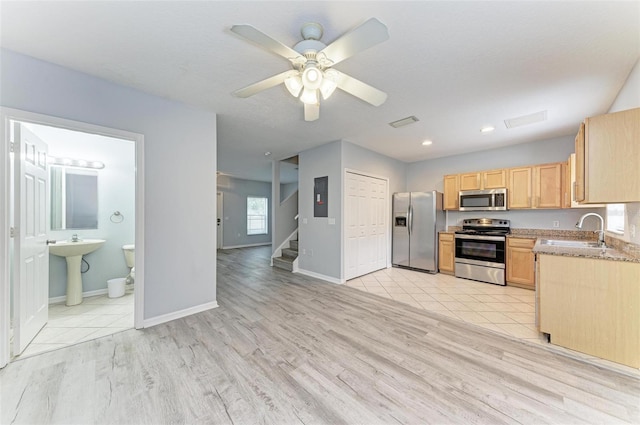 kitchen featuring light brown cabinets, sink, ceiling fan, light wood-type flooring, and appliances with stainless steel finishes