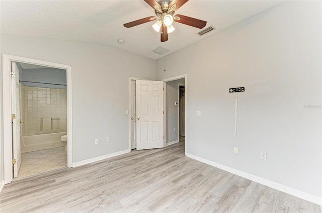 unfurnished bedroom featuring ensuite bath, ceiling fan, and light hardwood / wood-style floors