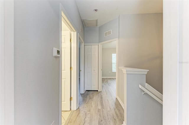 hallway with light hardwood / wood-style flooring