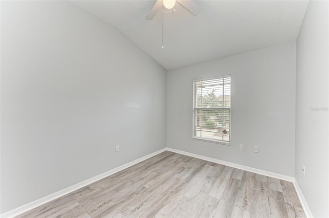 spare room featuring ceiling fan, light hardwood / wood-style floors, and vaulted ceiling