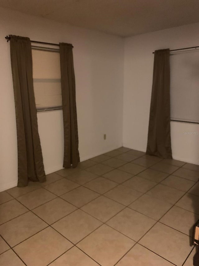 unfurnished bedroom featuring light tile floors