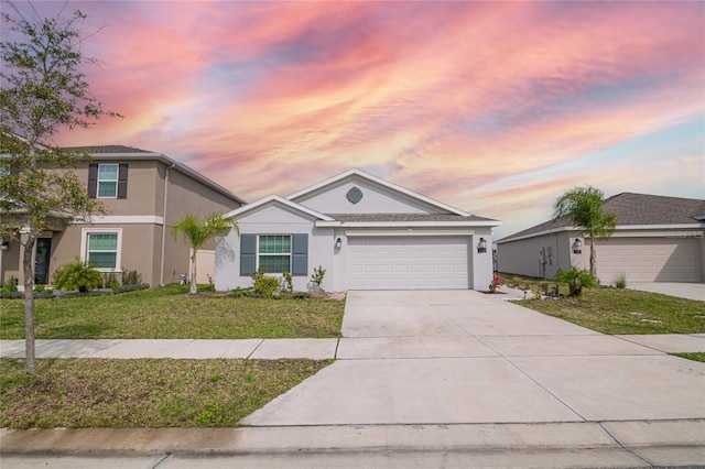 view of front of home featuring a yard and a garage