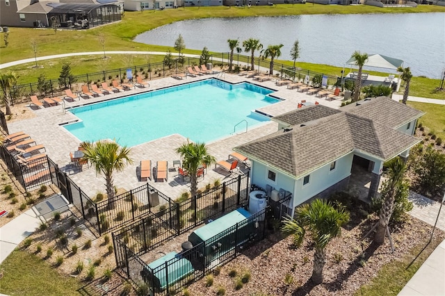 view of swimming pool with a yard, central AC, and a water view