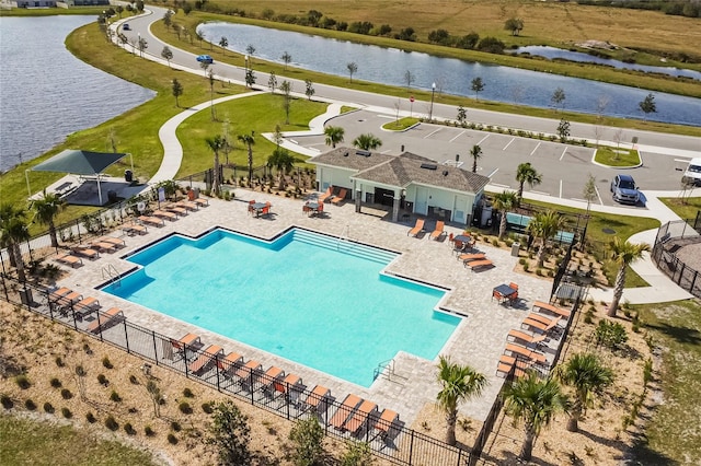 view of pool featuring a water view and a patio area