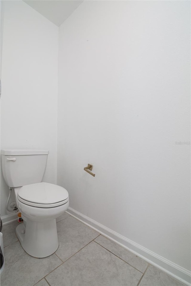 bathroom with tile flooring and toilet