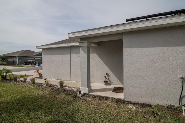 view of side of home with a yard