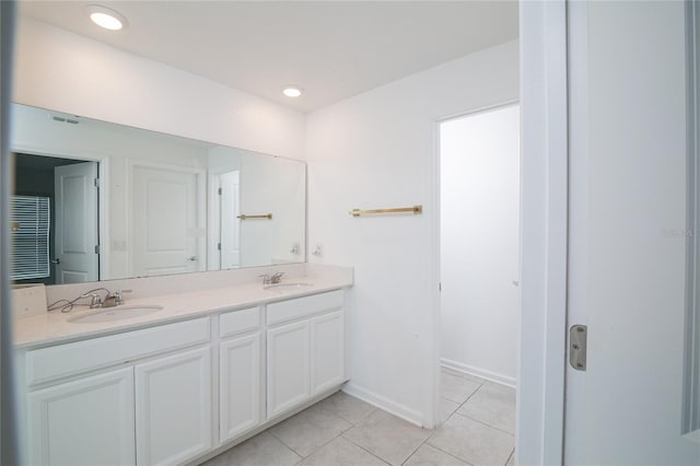 bathroom with large vanity, dual sinks, and tile flooring