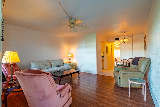 living room with tile flooring and ceiling fan with notable chandelier