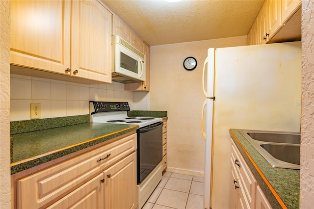 kitchen with light tile floors, a textured ceiling, white appliances, backsplash, and sink