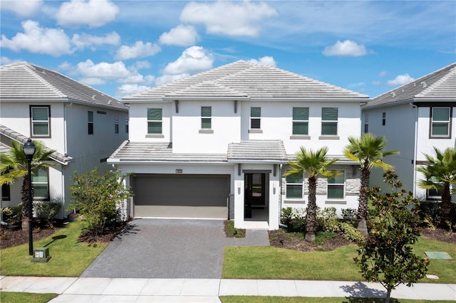 view of front of property featuring a front lawn and a garage