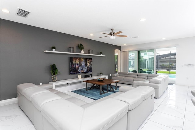 living room with light tile floors and ceiling fan