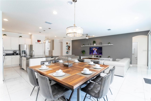 tiled dining area featuring ceiling fan