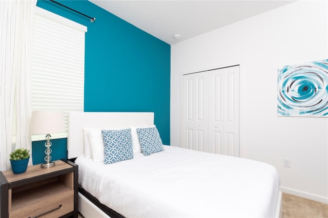 bedroom featuring light carpet and a closet