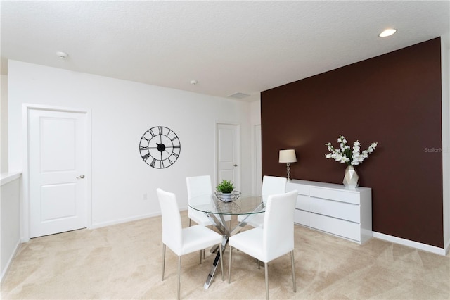 dining room featuring light colored carpet