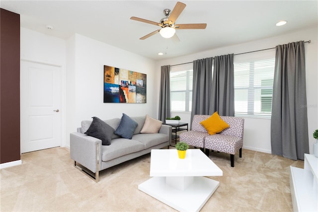 carpeted living room featuring ceiling fan