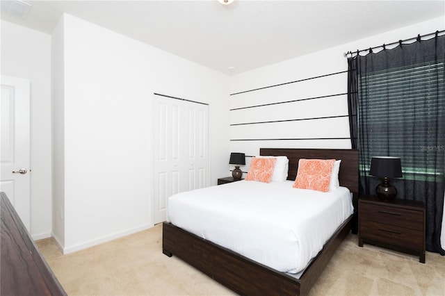 bedroom with light carpet and a closet