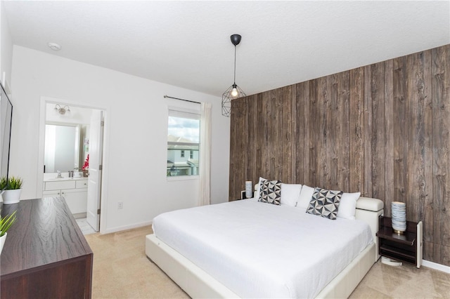 carpeted bedroom featuring wooden walls and connected bathroom