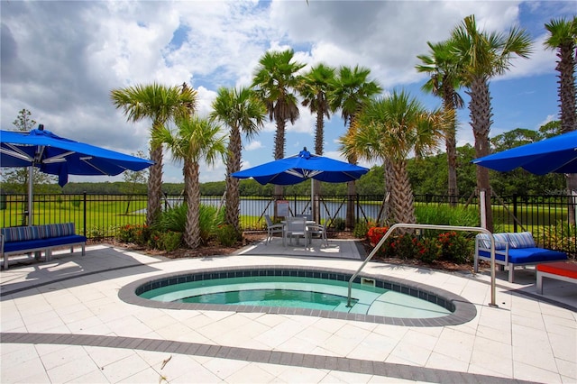 view of pool with a patio and an in ground hot tub