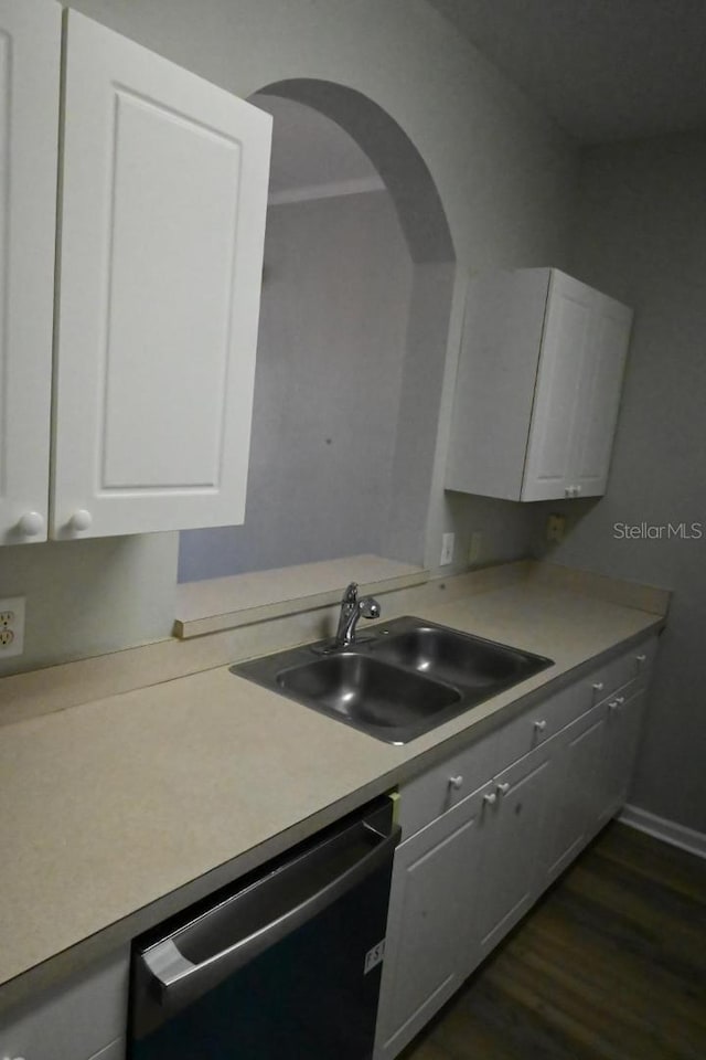 kitchen with dark wood-type flooring, white cabinetry, dishwasher, and sink