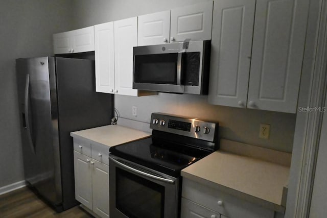 kitchen featuring white cabinetry, dark wood-type flooring, and stainless steel appliances