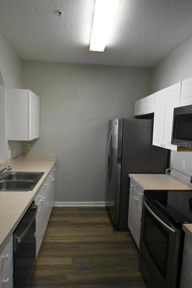 kitchen featuring electric range, dark wood-type flooring, white cabinetry, dishwasher, and sink