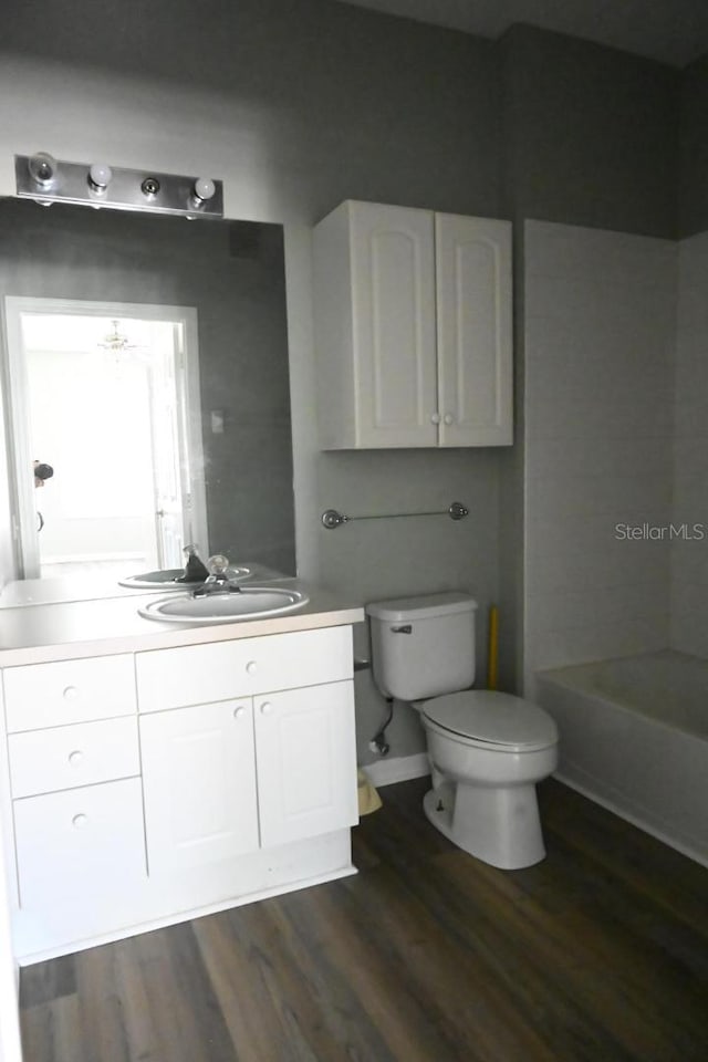 full bathroom featuring shower / bathing tub combination, toilet, wood-type flooring, and vanity