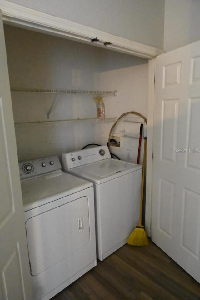 laundry area with washer and clothes dryer and dark wood-type flooring