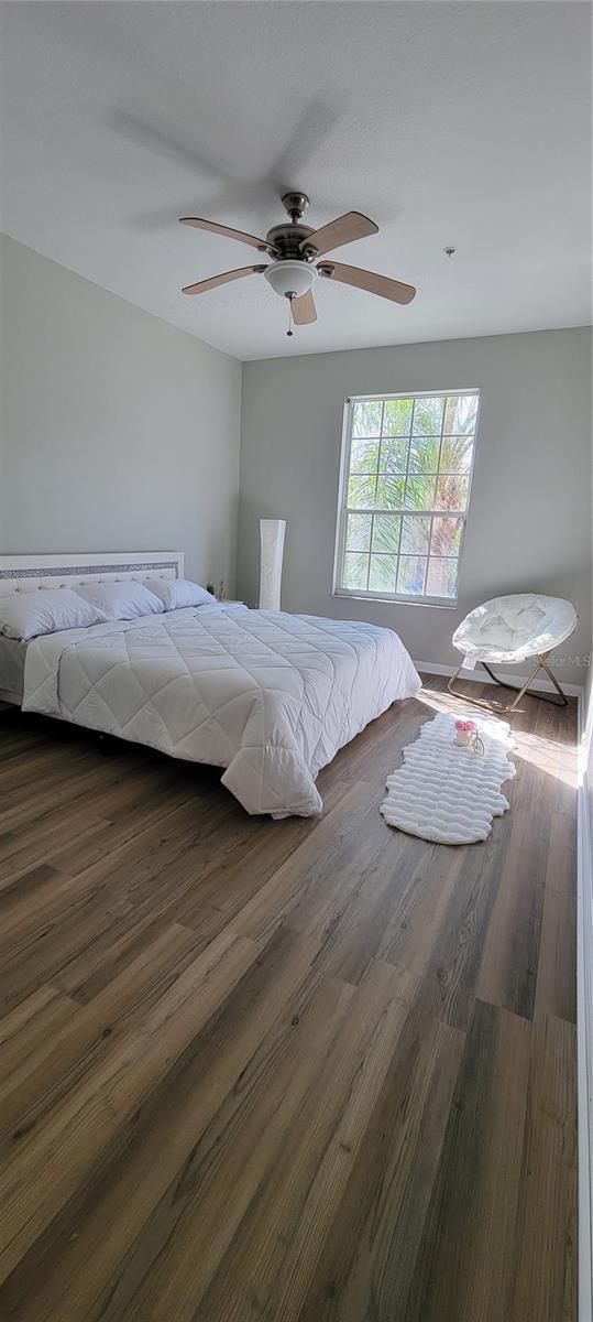 bedroom with ceiling fan and dark hardwood / wood-style flooring