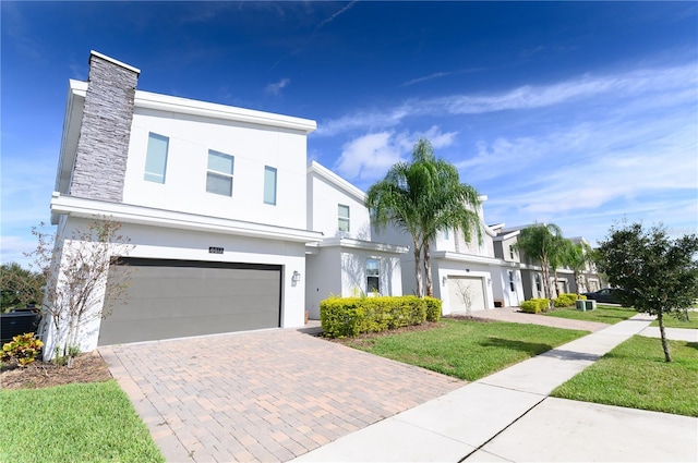 view of front of house featuring a front yard and a garage