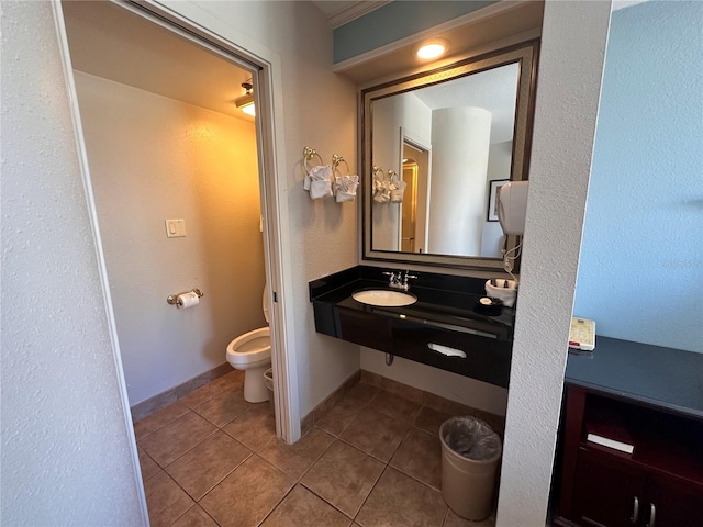 bathroom with sink, tile flooring, and toilet