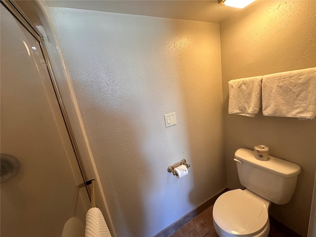 bathroom with toilet and tile flooring