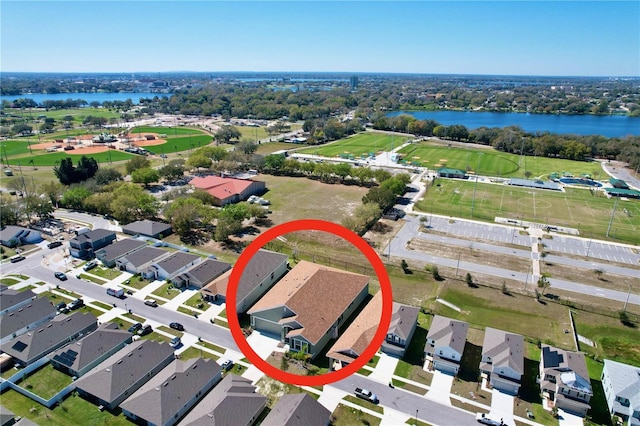 birds eye view of property with a water view