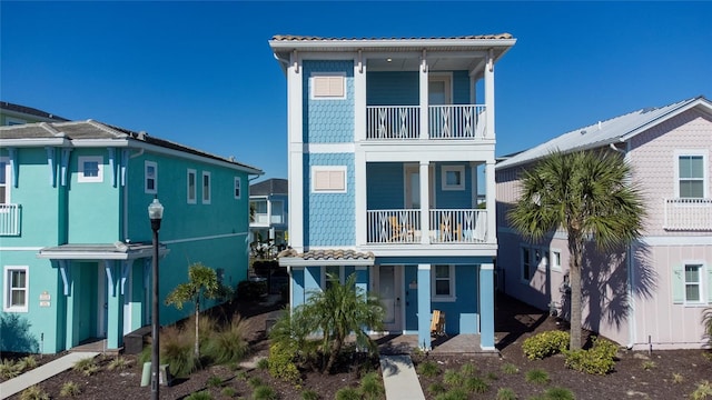 back of property with a balcony