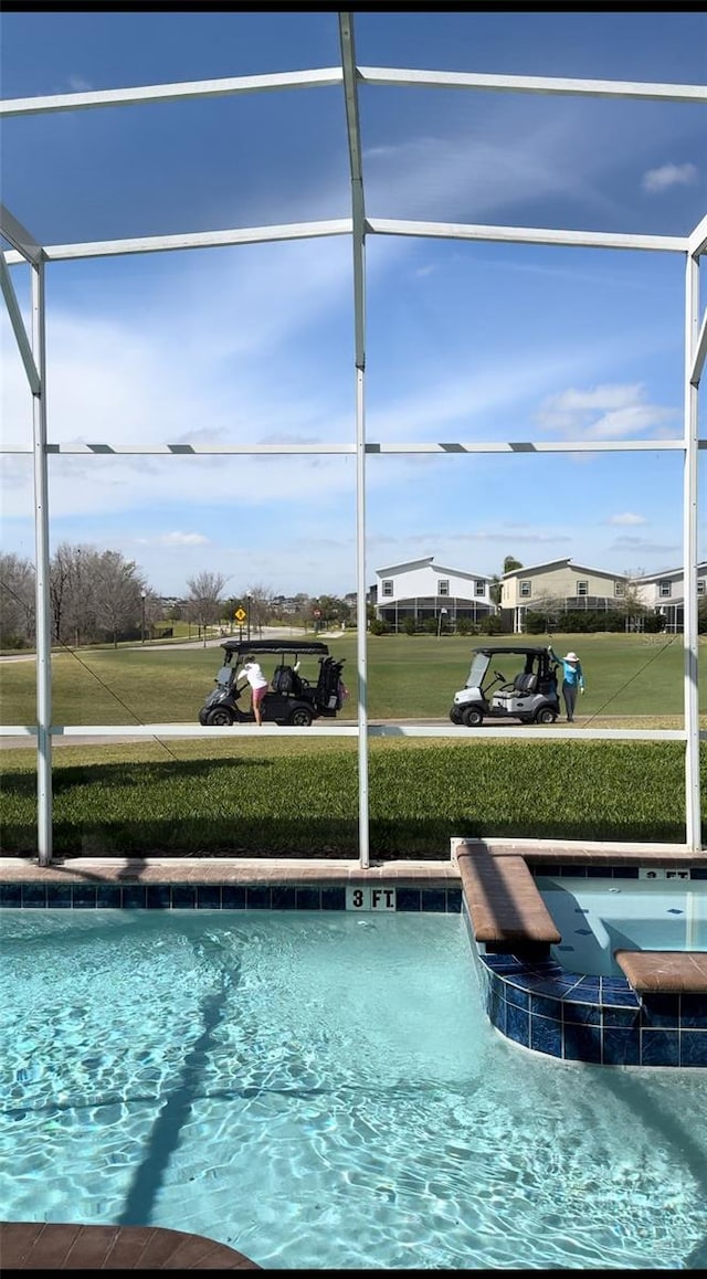 view of swimming pool featuring a lawn